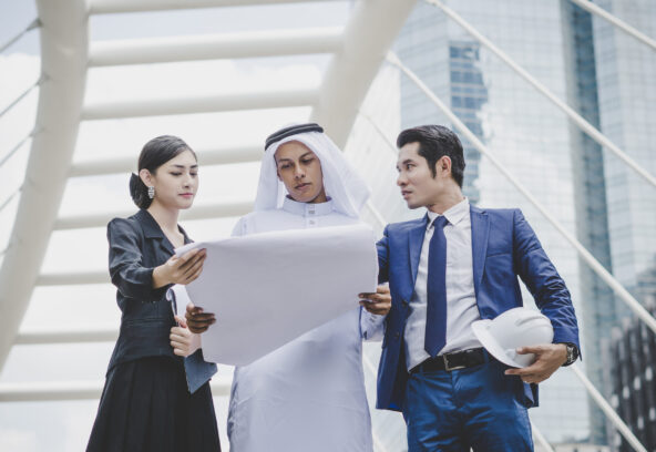 Business coworkers discussing new ideas and brainstorming together looking at new project document.