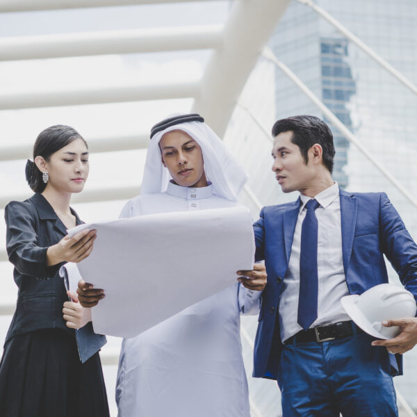 Business coworkers discussing new ideas and brainstorming together looking at new project document.