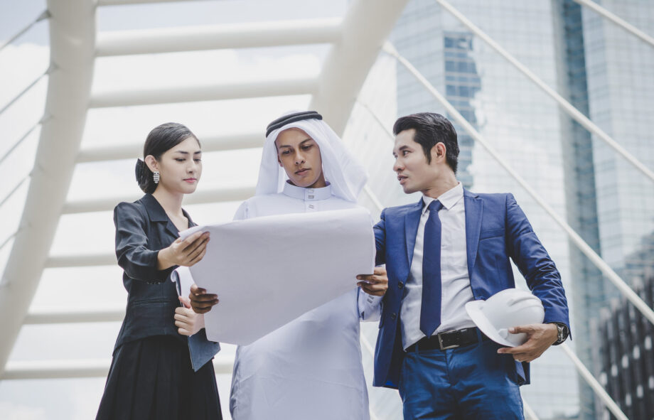 Business coworkers discussing new ideas and brainstorming together looking at new project document.